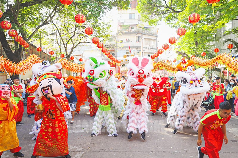 Hình ảnh múa lân với trang phục rực rỡ và động tác uyển chuyển